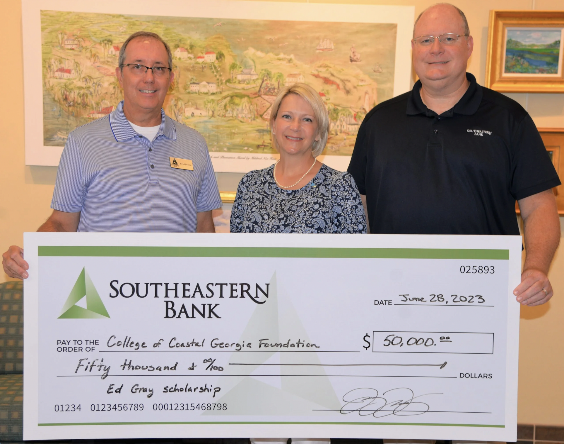 Southeastern Bank's Jay Torbert and Brad Brown present memorial scholarship check to College of Coastal Georgia President Dr. Michelle Johnston